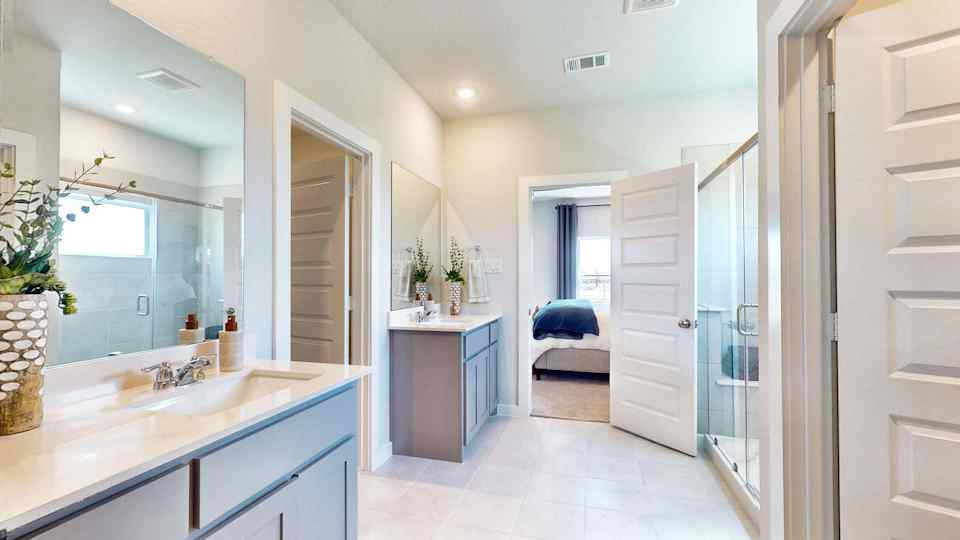 A bathroom with a sink and a bed.