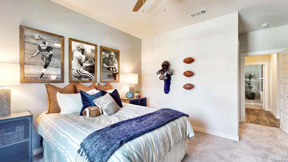 A bedroom with a bed and art on the wall.