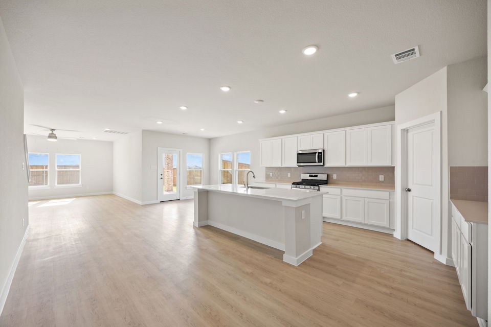 A large kitchen with white cabinets.