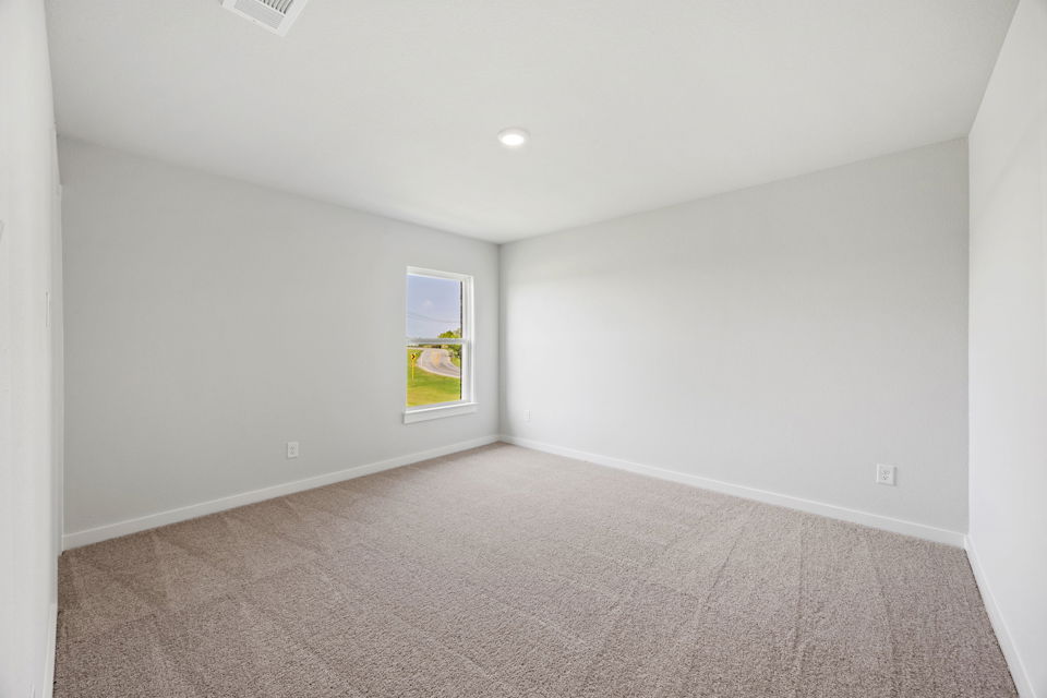 A room with a carpet and a rug.