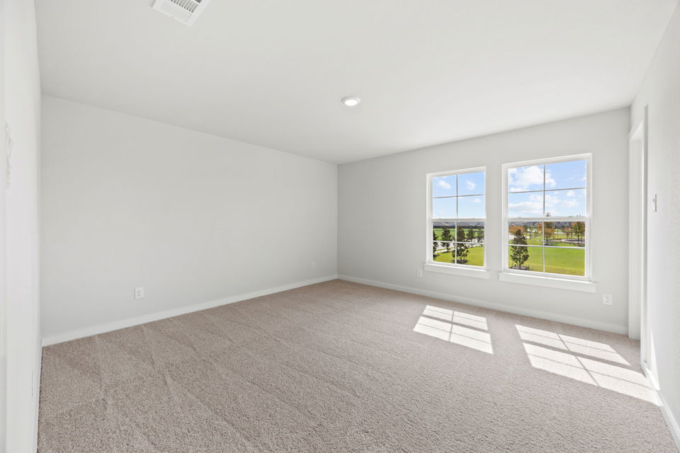A room with a window and a rug in it.