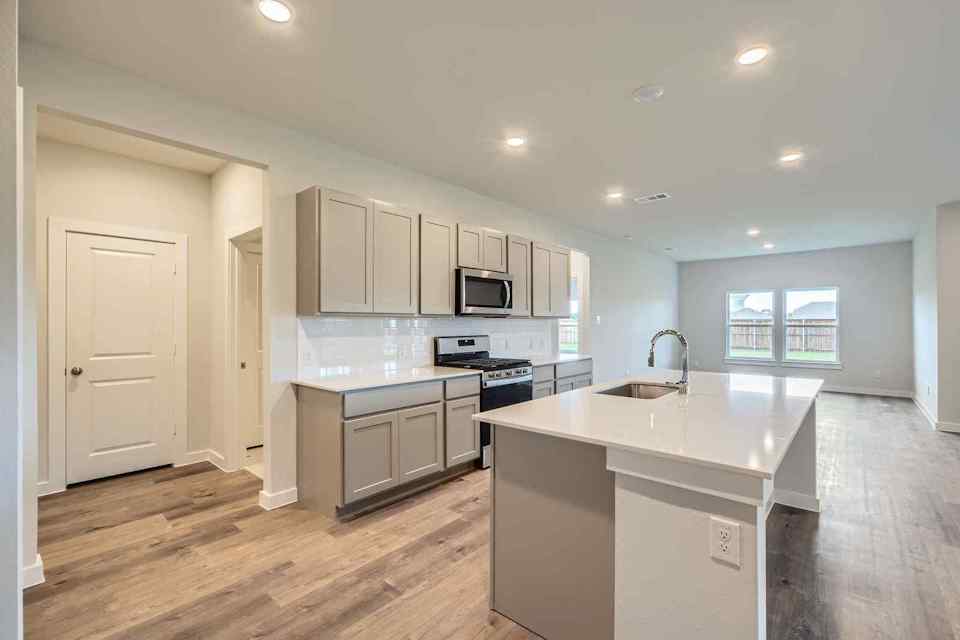 A kitchen with white cabinets.