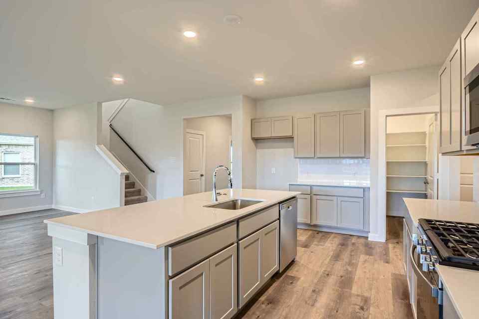 A kitchen with white cabinets.