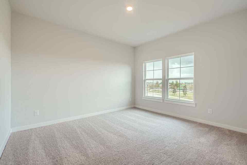 A room with a window and a carpet.