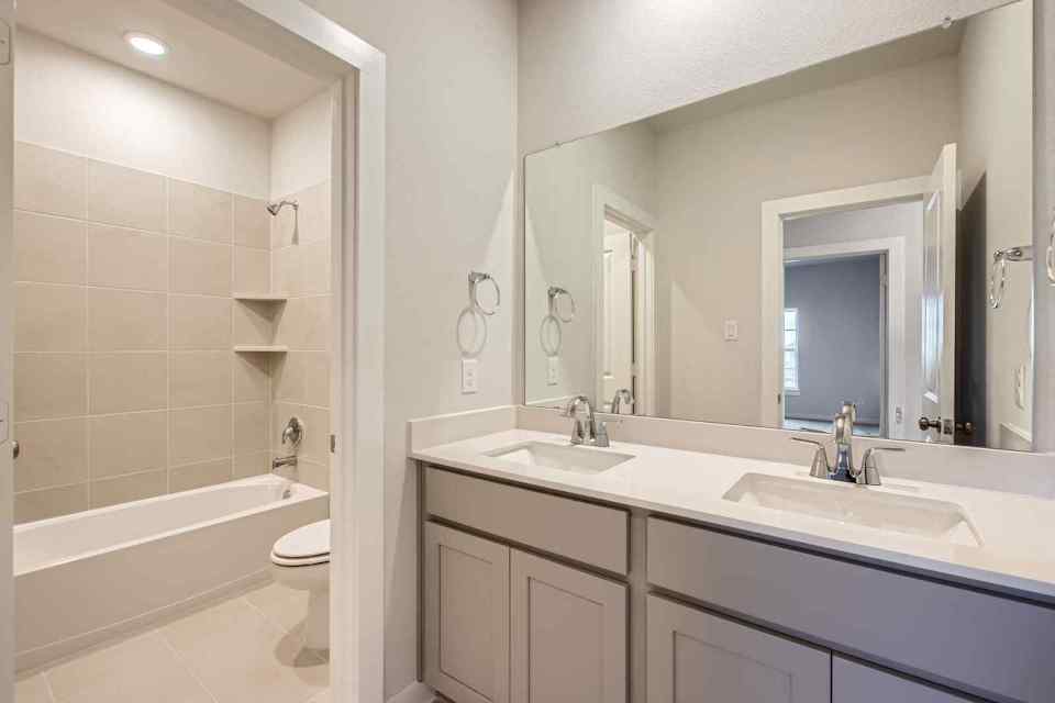 A bathroom with a tub sink and toilet.