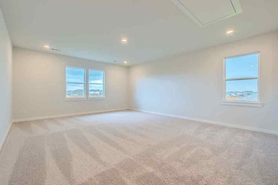 A room with a bed and windows.