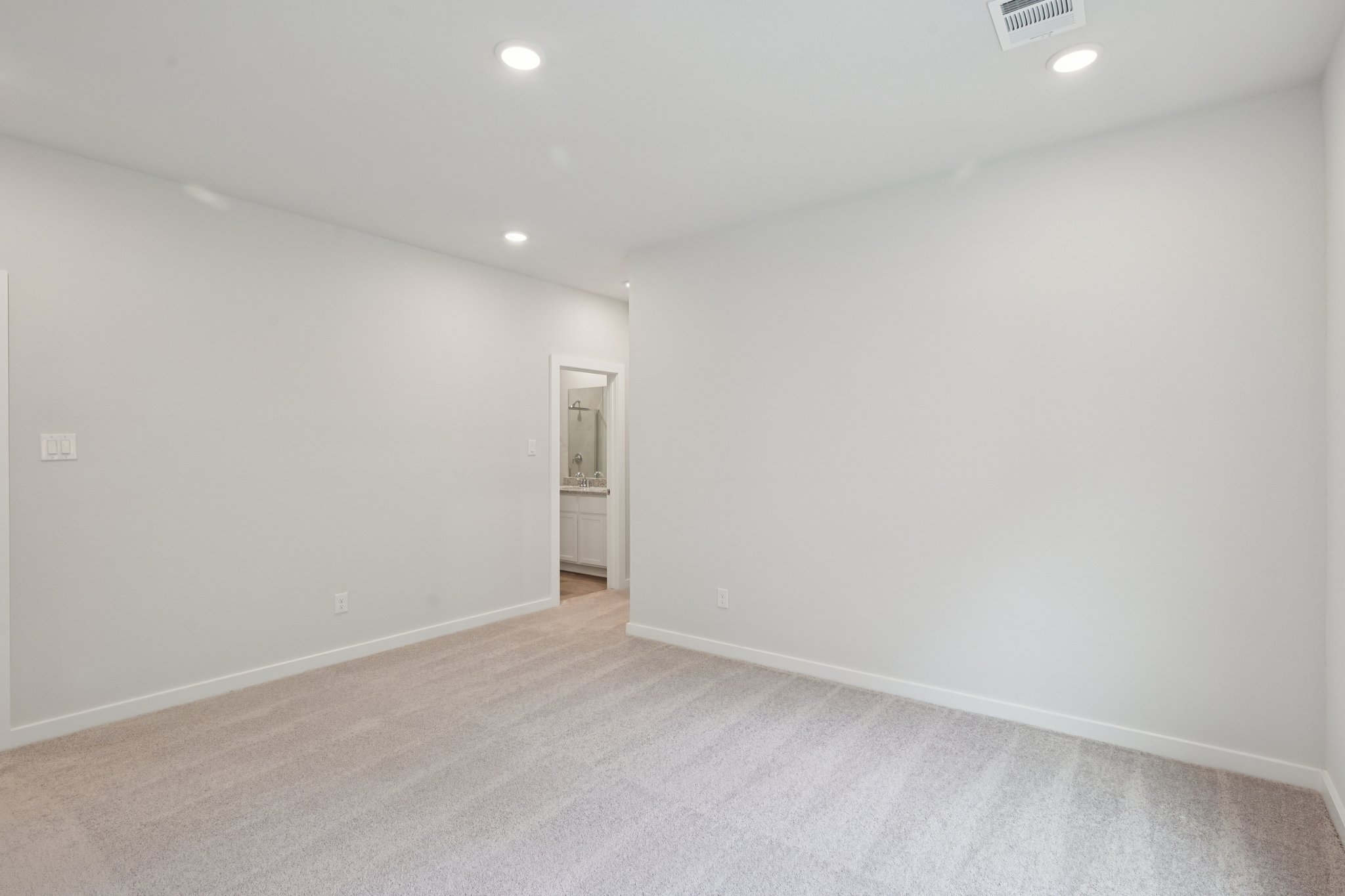 A hallway with white walls.