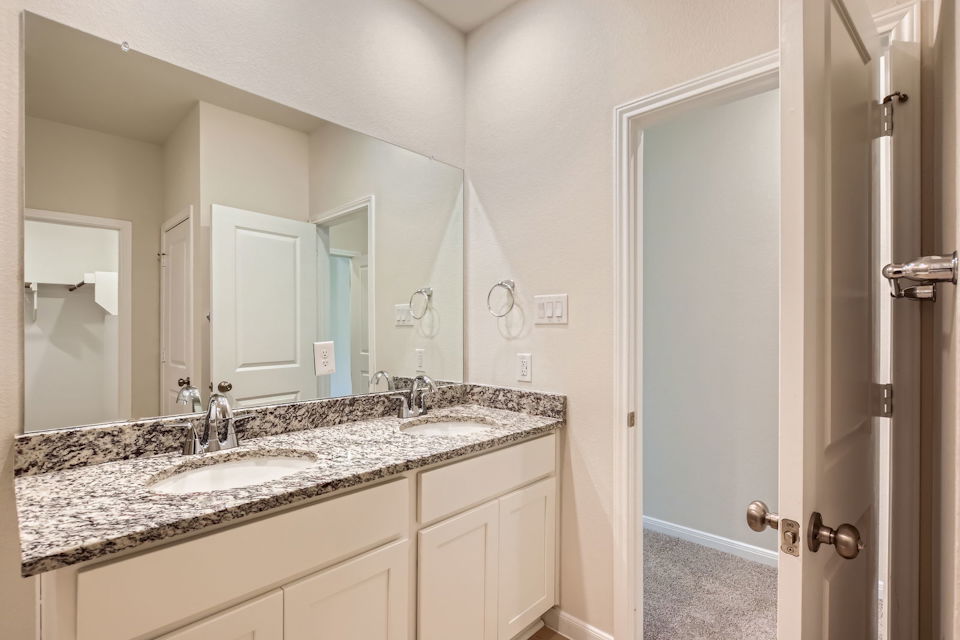 A bathroom with a marble countertop.