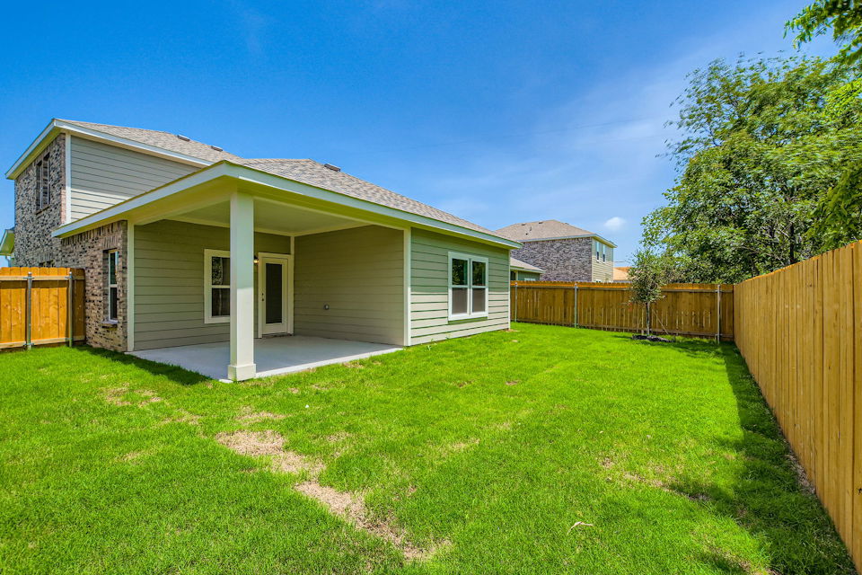 A house with a fence and grass.