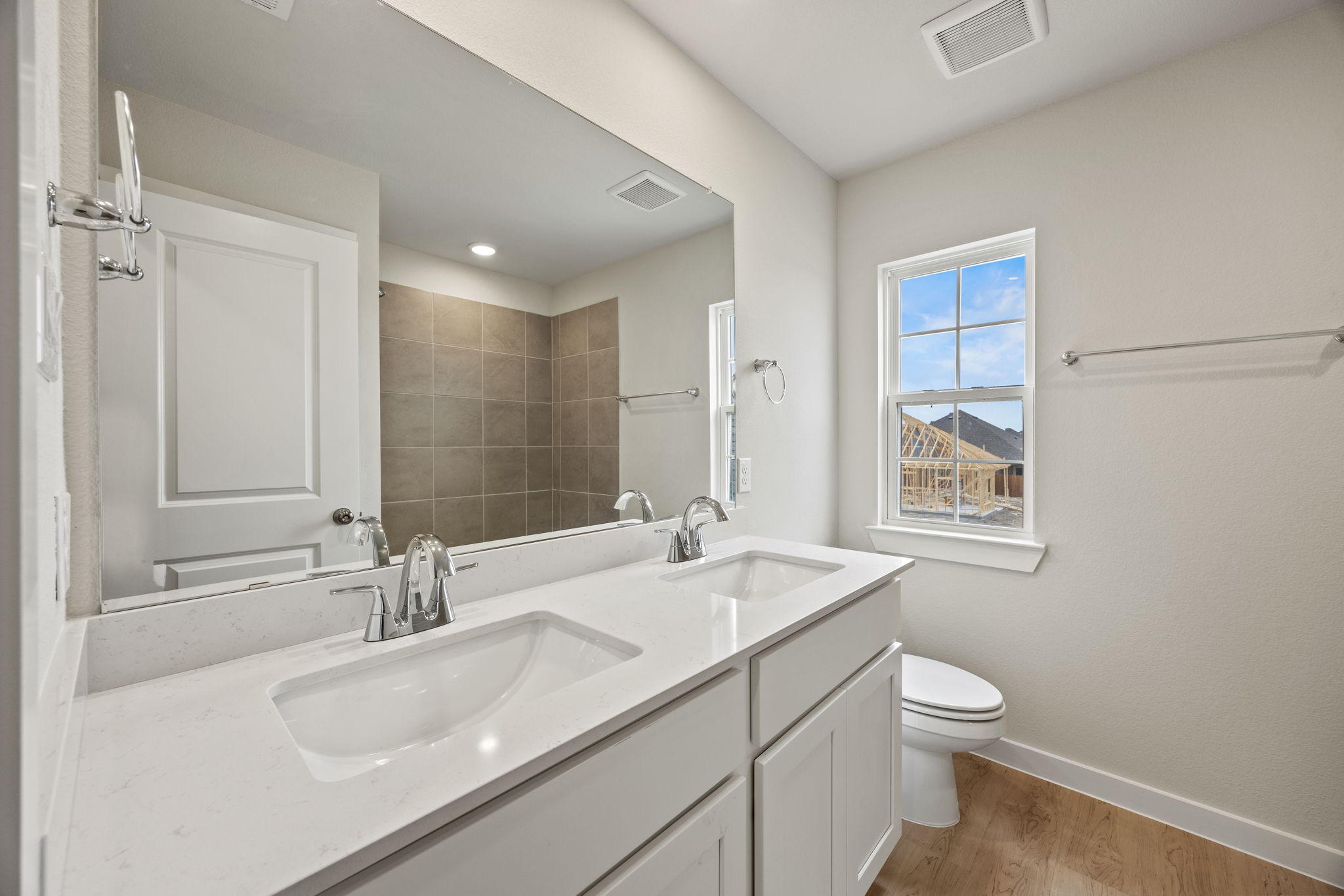 A bathroom with a large mirror.