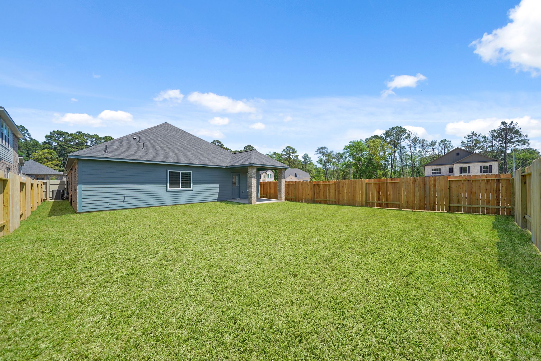 A fenced in yard with houses.