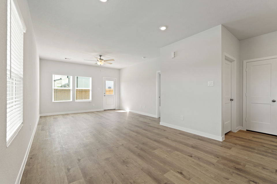 A room with white walls and a wood floor.
