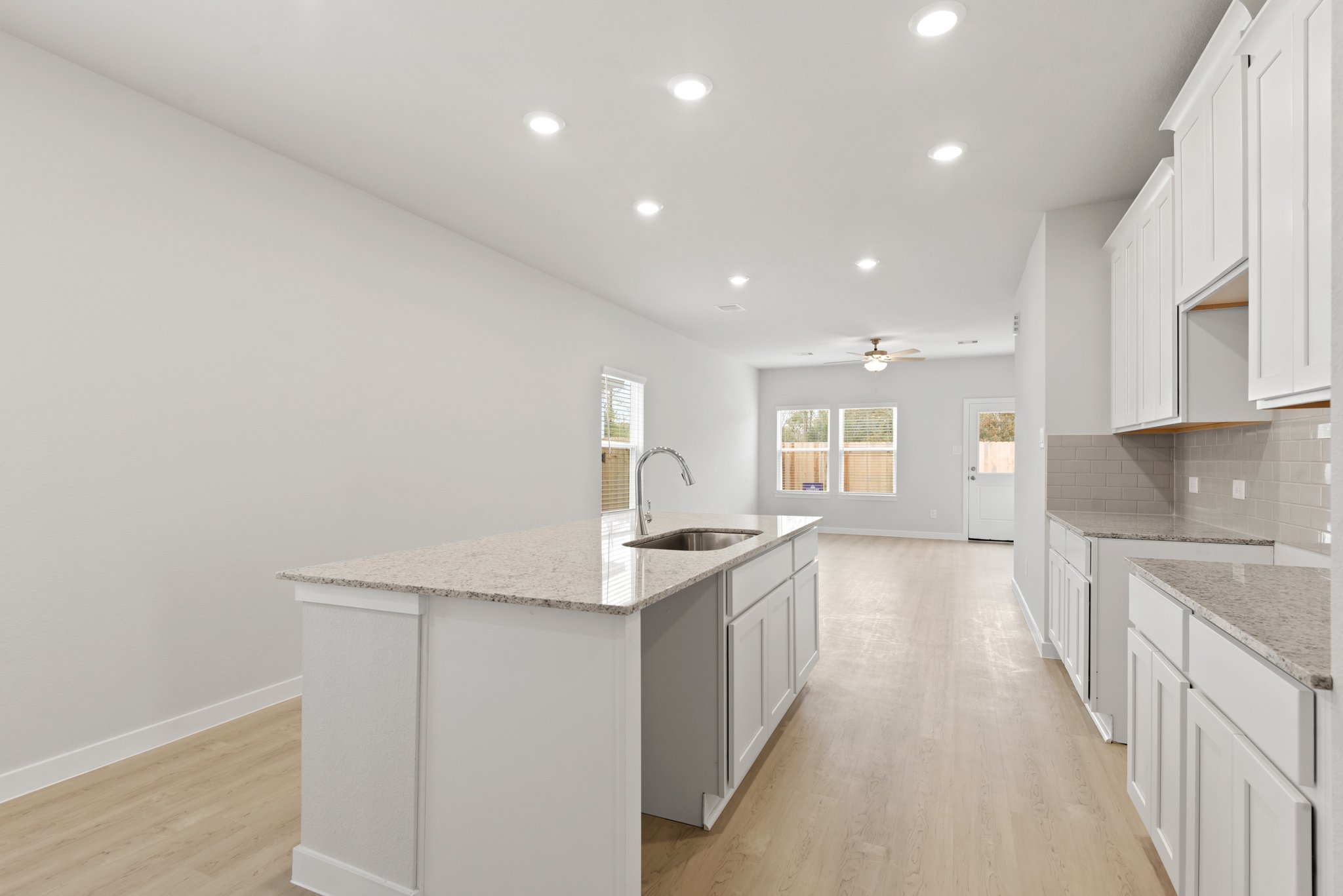A kitchen with white cabinets.