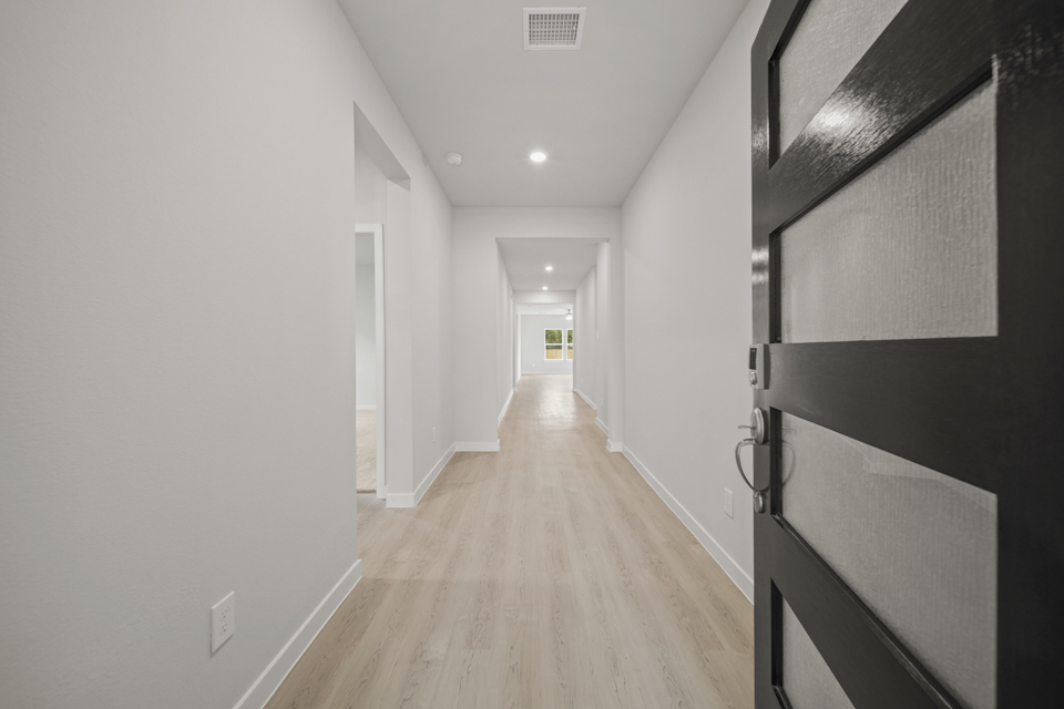 A long hallway with white walls.