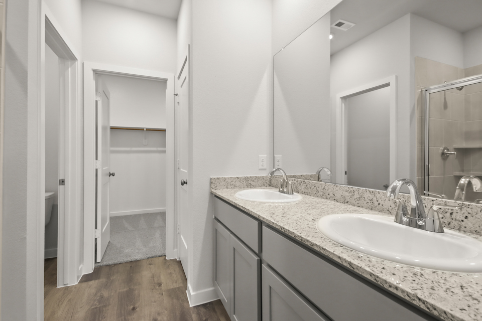 A bathroom with a large mirror.