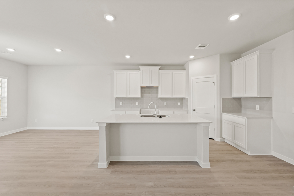 A large white kitchen with white cabinets.