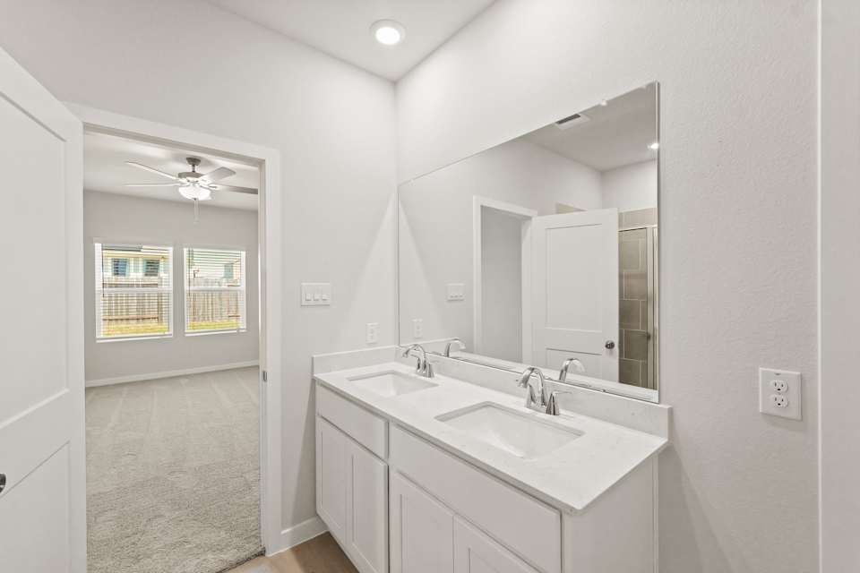 A bathroom with a large mirror.
