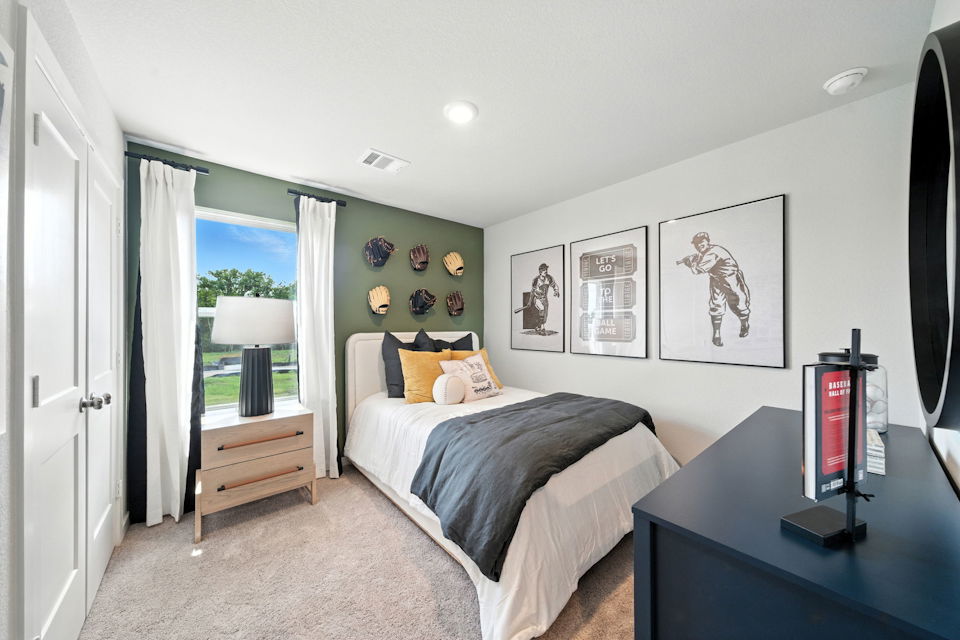 A bedroom with a bed and a desk.