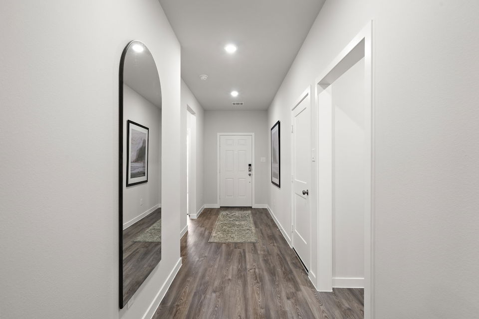 A hallway with white doors.