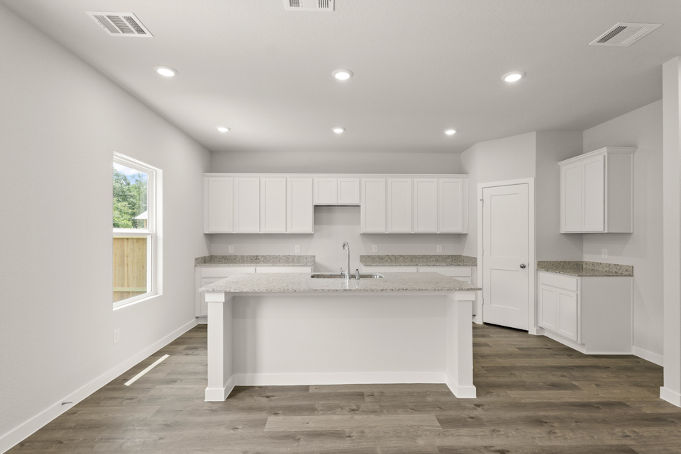 A kitchen with white cabinets.