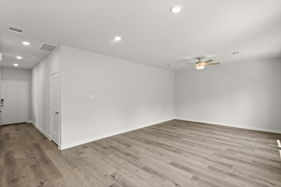 A room with a wood floor and white walls.