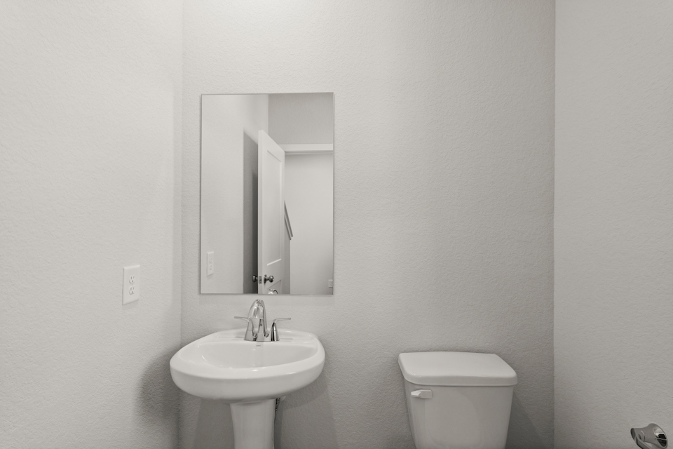 A bathroom with a sink and a mirror.