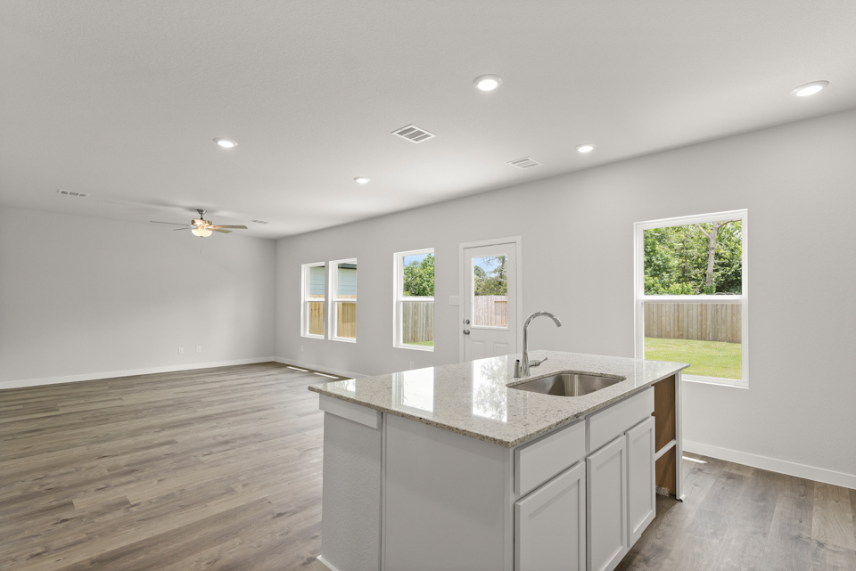 A kitchen with a large window.