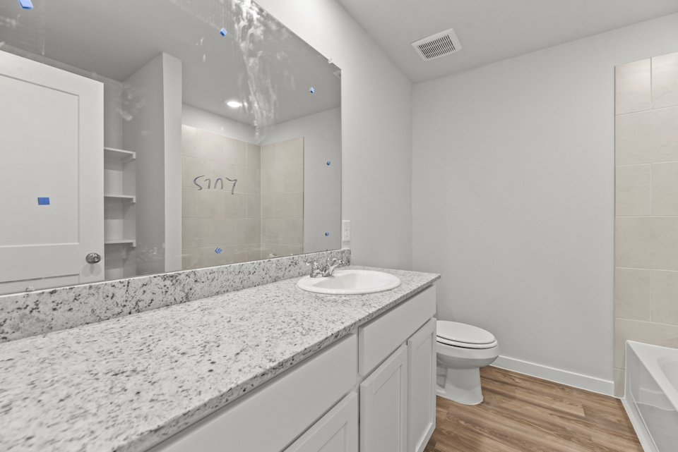 A bathroom with a marble countertop.