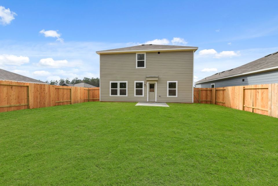 A house with a green lawn.