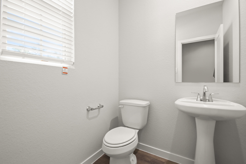 A bathroom with a toilet and sink.