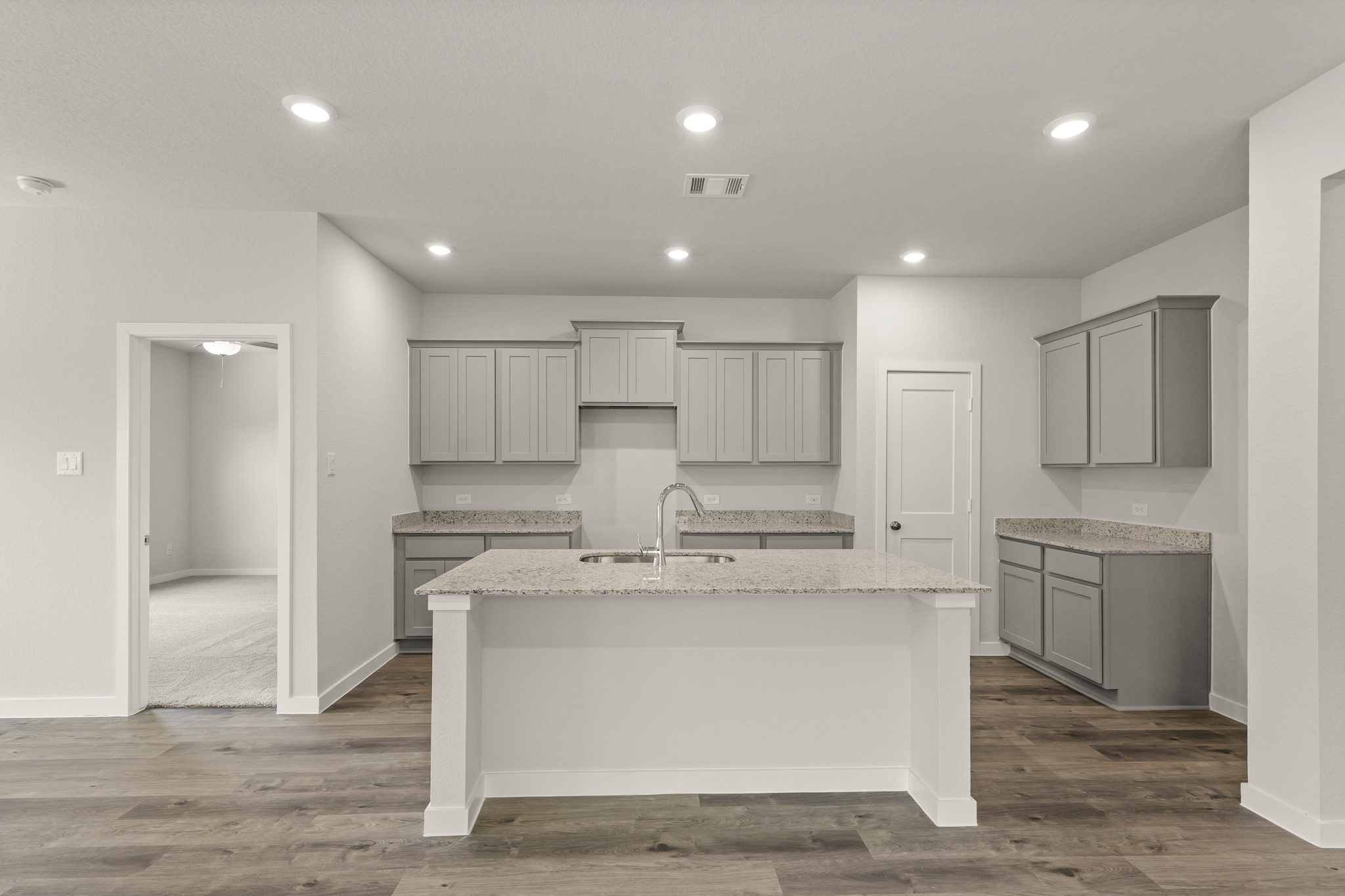 A kitchen with white cabinets.