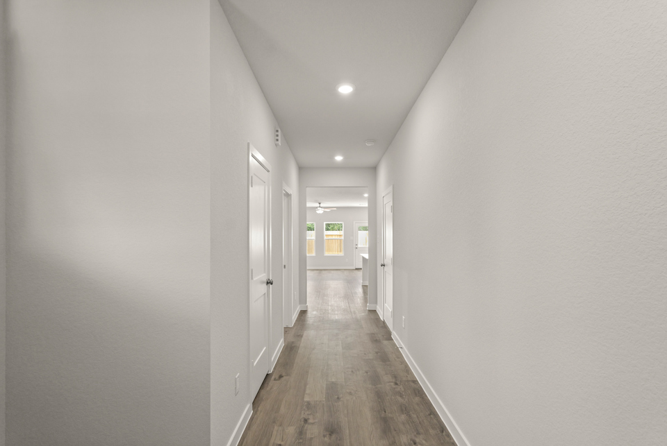 A hallway with white doors.