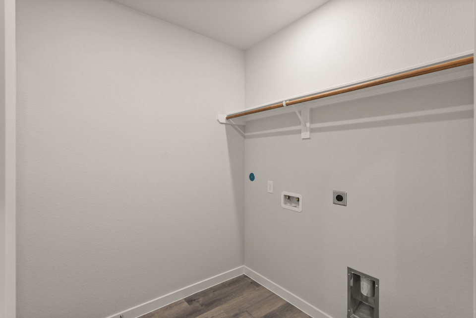 A white wall with a wood beam.