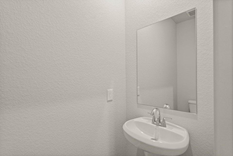 A bathroom with a large mirror.