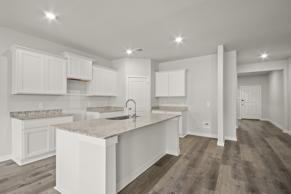 A kitchen with white cabinets.