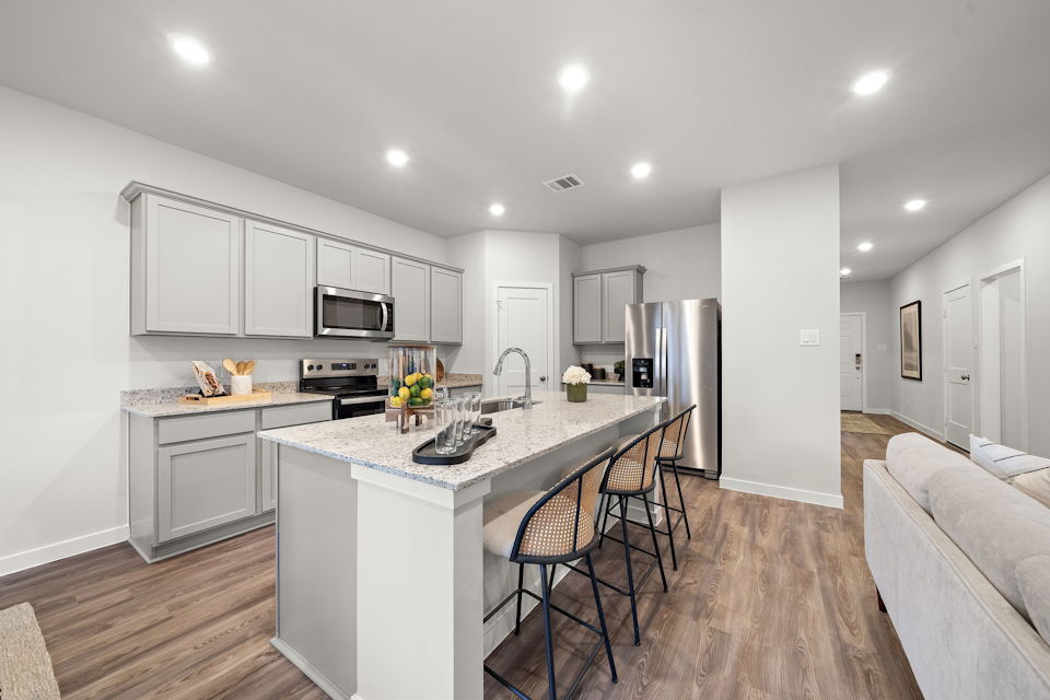 A kitchen with white cabinets.