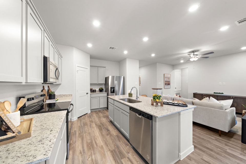 A kitchen with white cabinets.