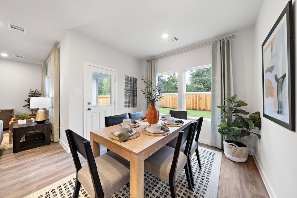 A dining room table with chairs.