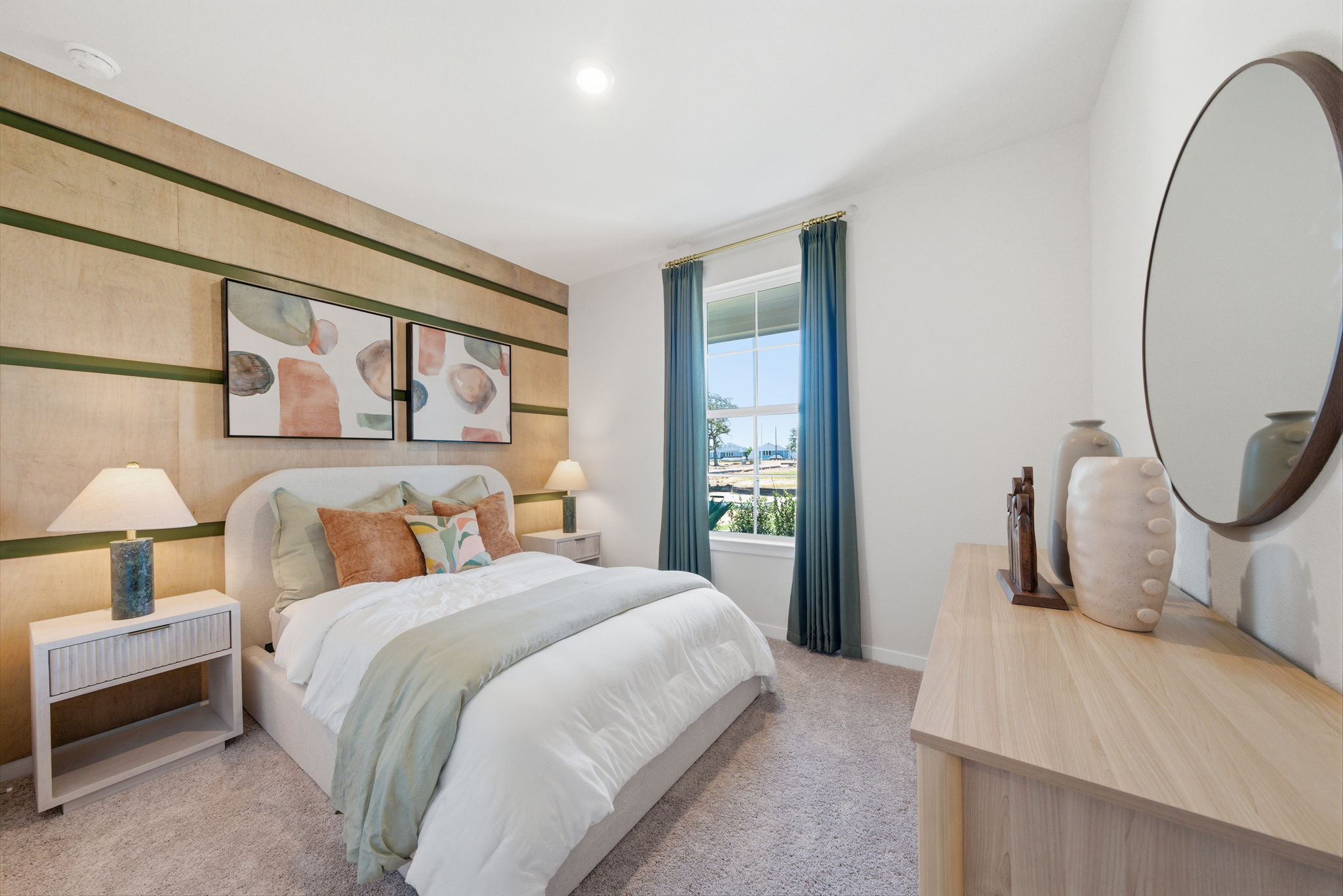 A bedroom with a large mirror.