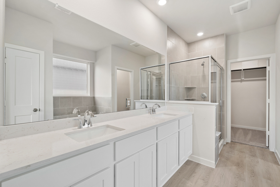 A bathroom with white cabinets.