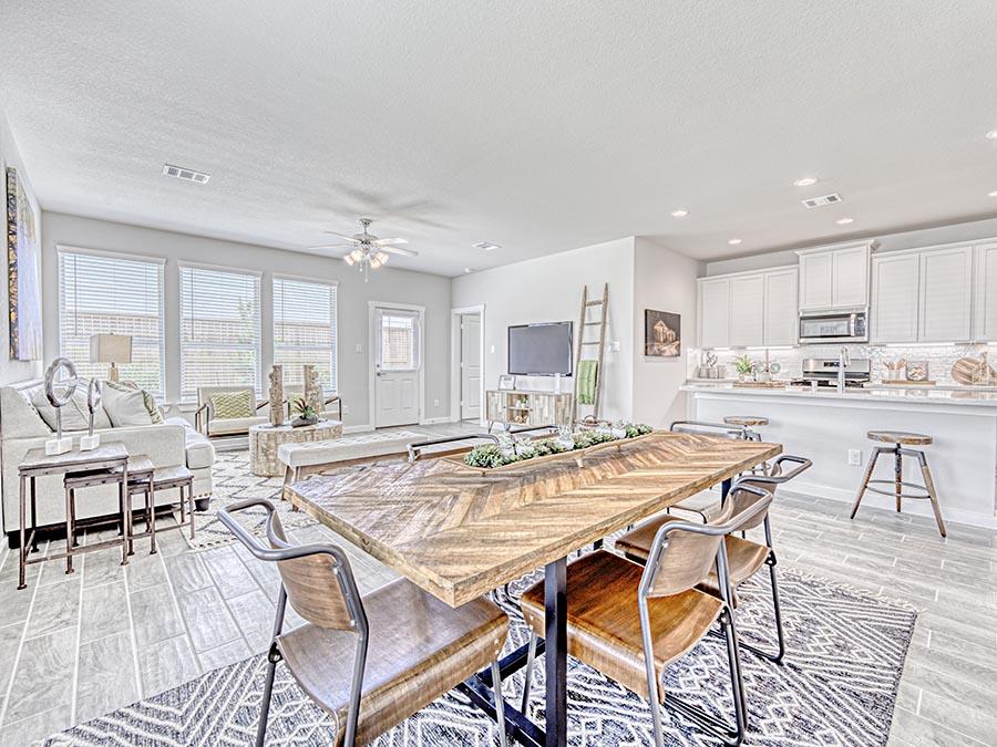 A large kitchen with a dining table.