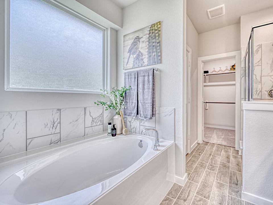 A bathroom with a tub and sink.