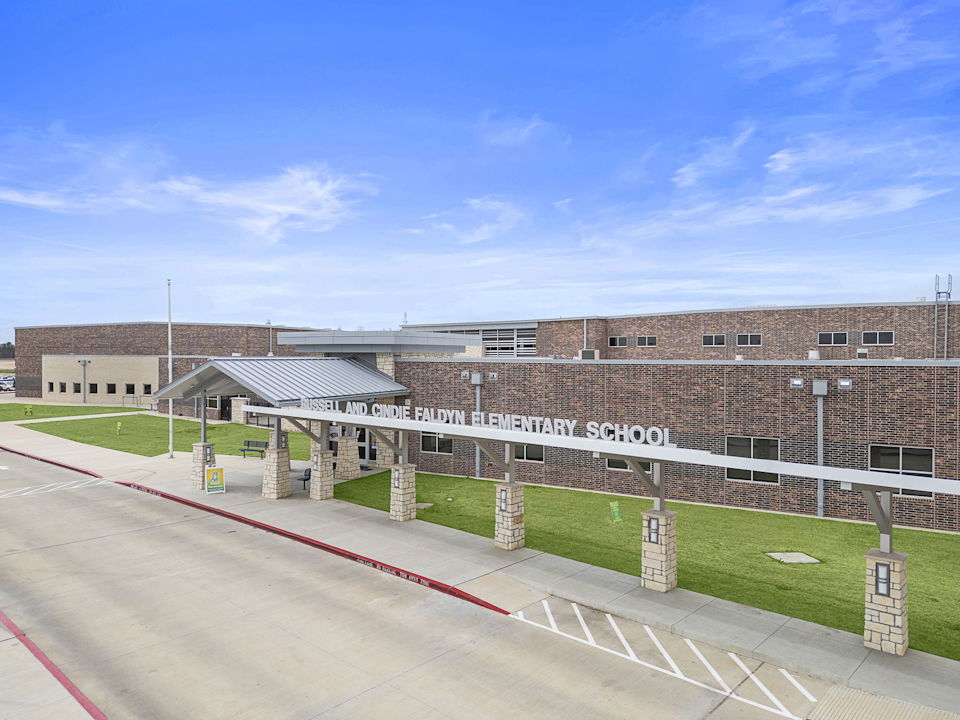 A building with a sign in front.