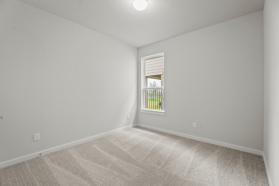 A room with a window and carpet.