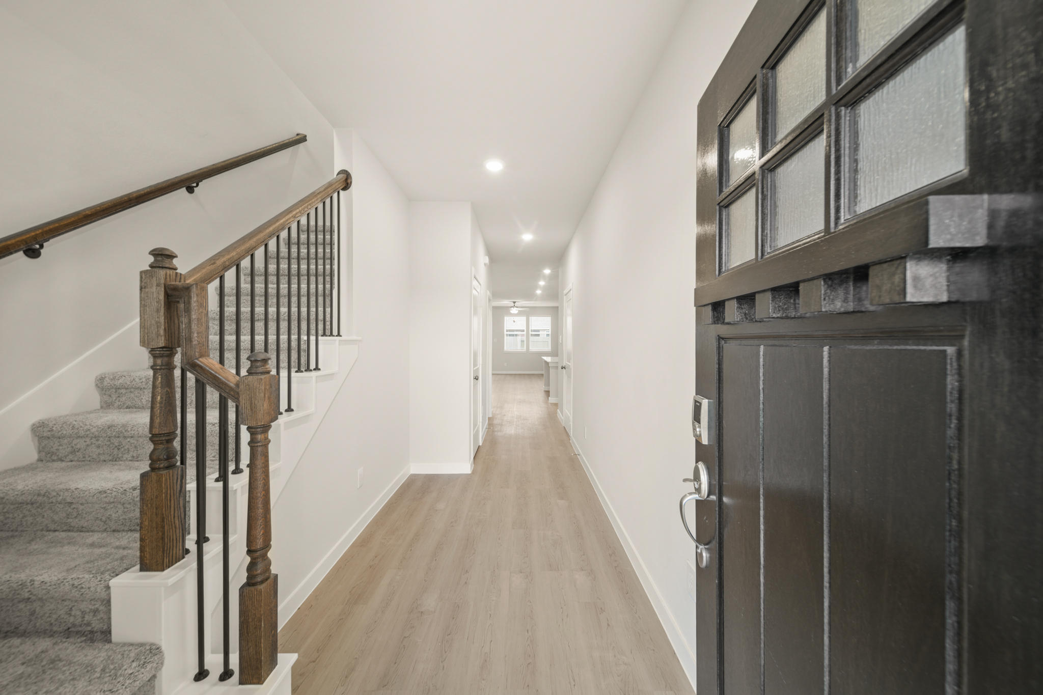 A hallway with black railings.