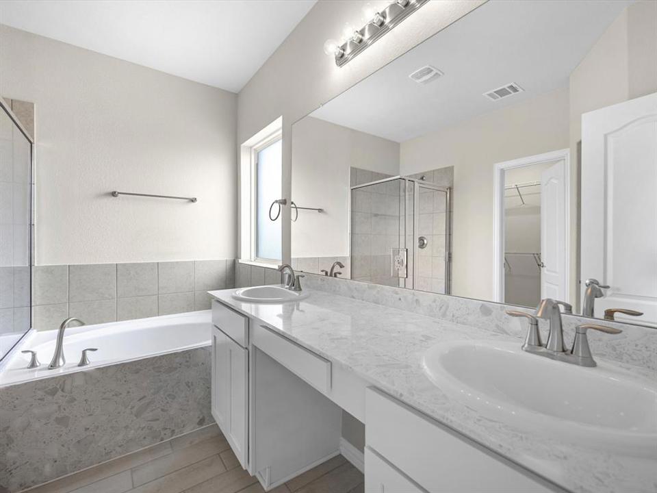 A bathroom with a tub sink and a bathtub.