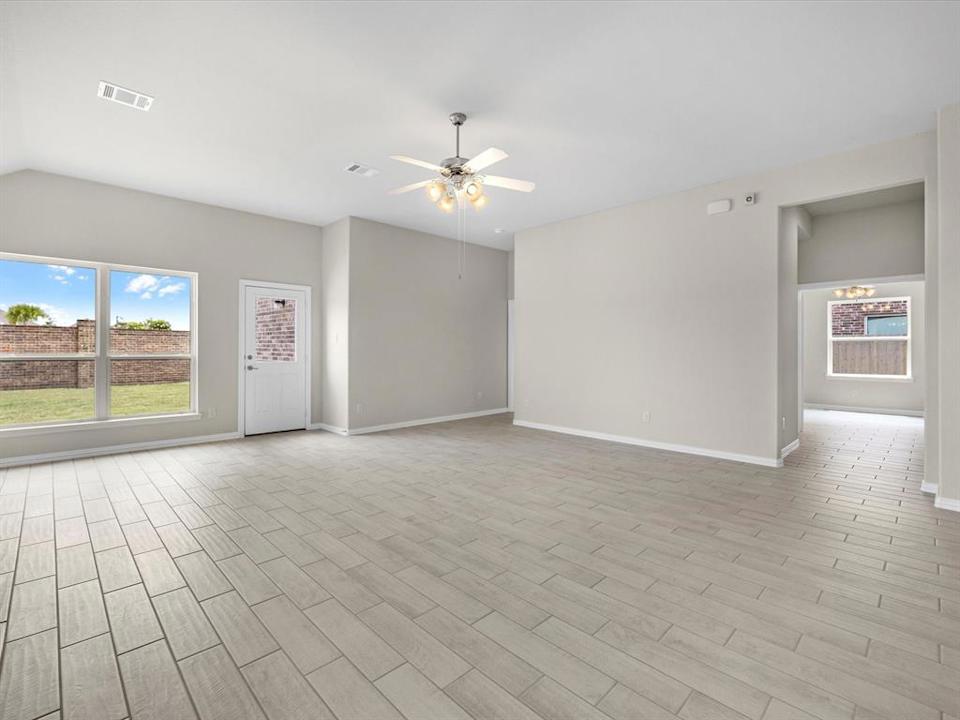 A room with a tile floor and a ceiling fan.