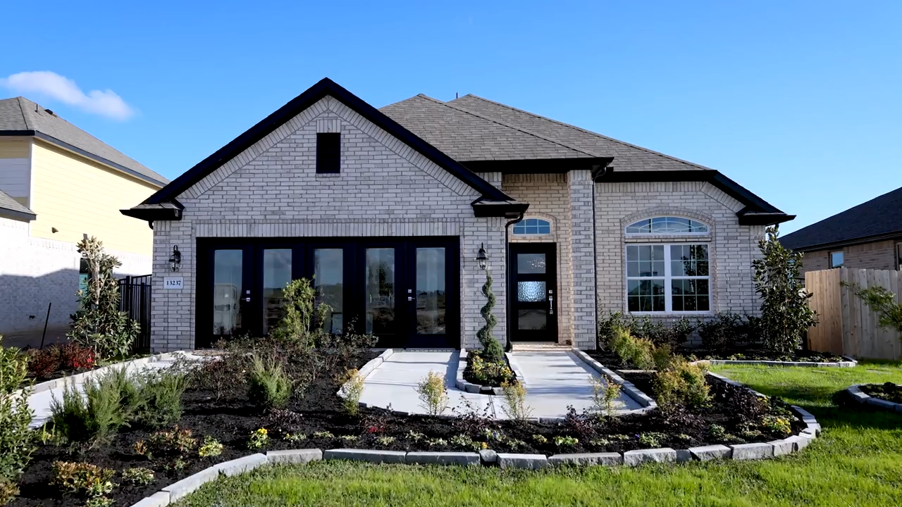 A house with a pool in the front.