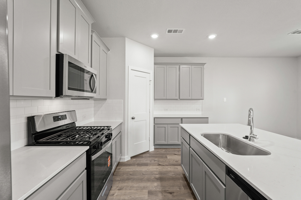 A kitchen with white cabinets.