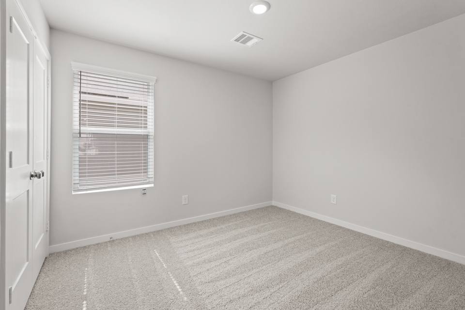 A room with a window and a door.